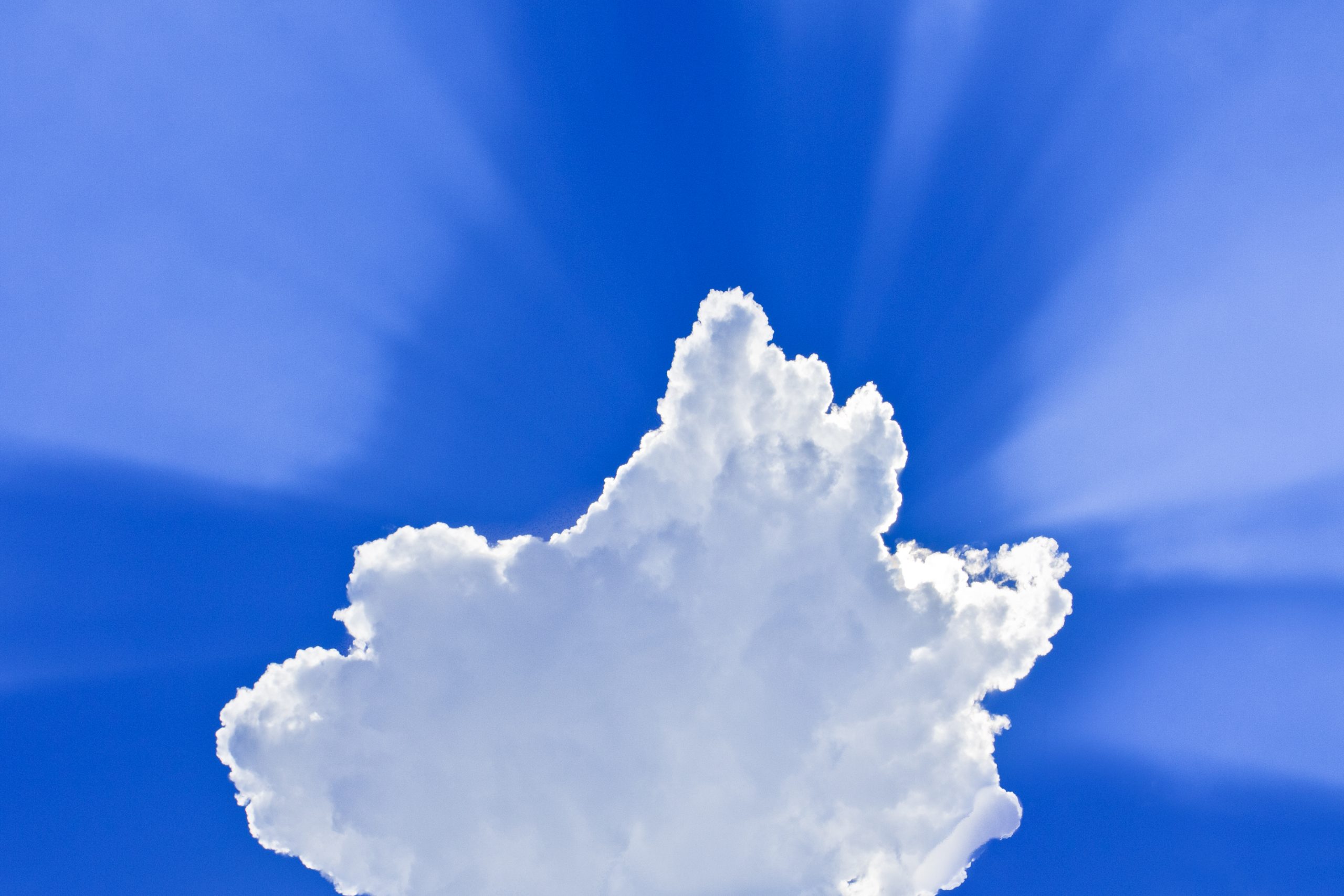 Clouds with the rays on a blue sky