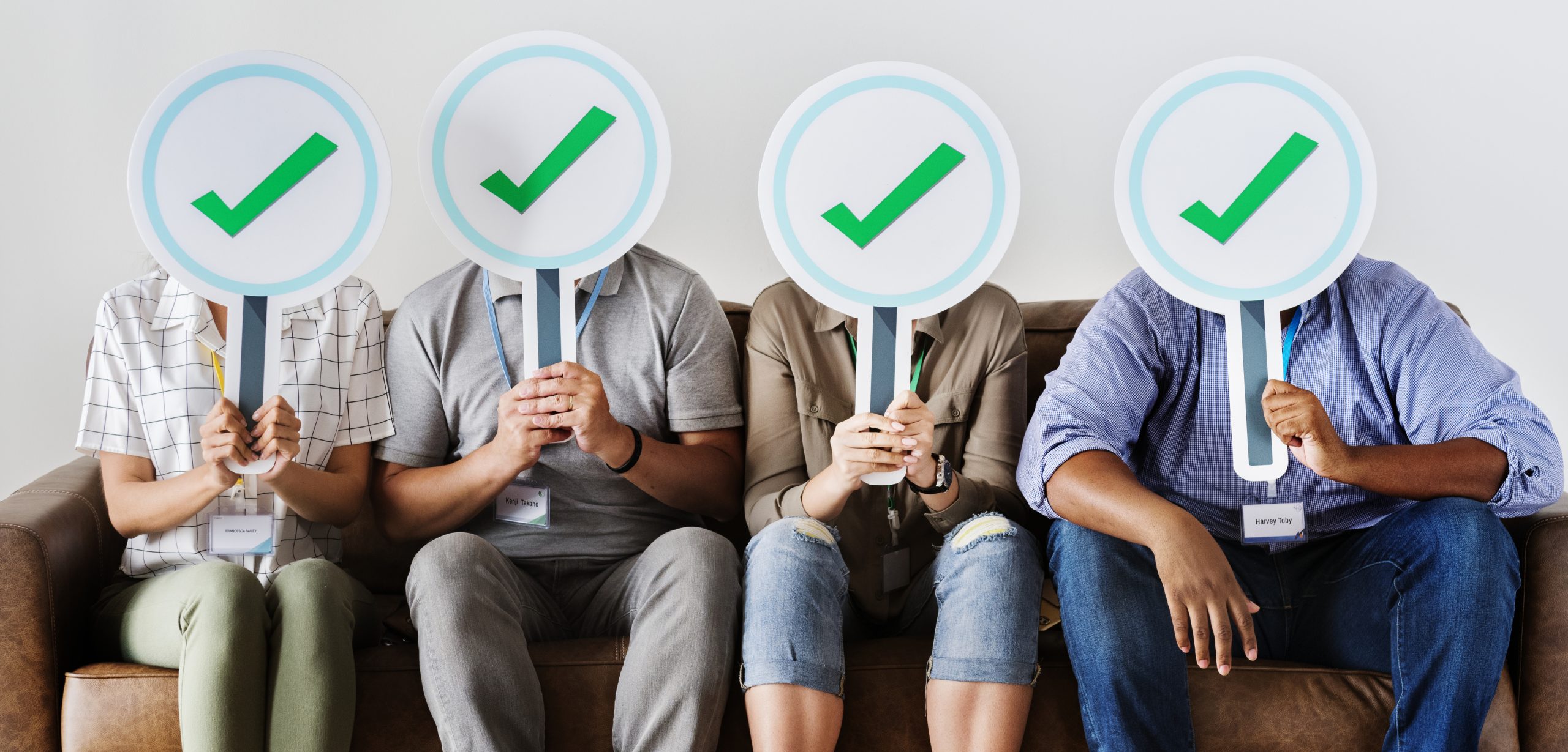 Group of people holding check icons